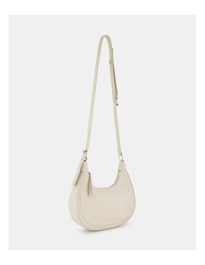 Arvada Curved Crossbody Bag in Cream