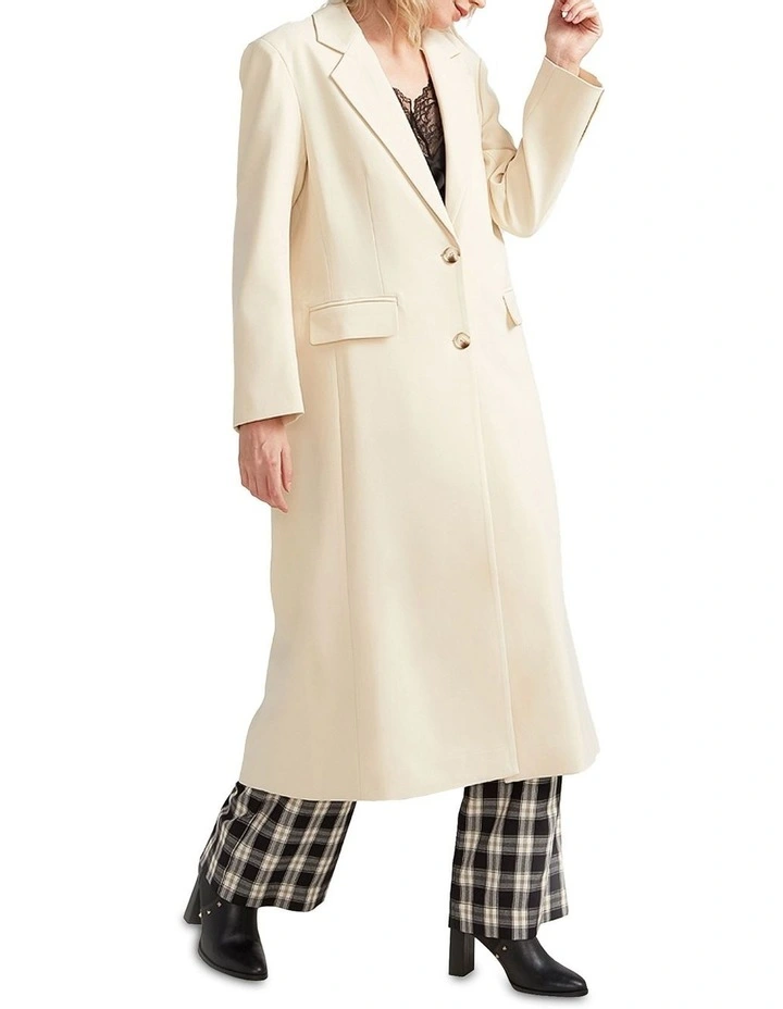 Transcendent Asymmetric Split Hem Coat in Cream